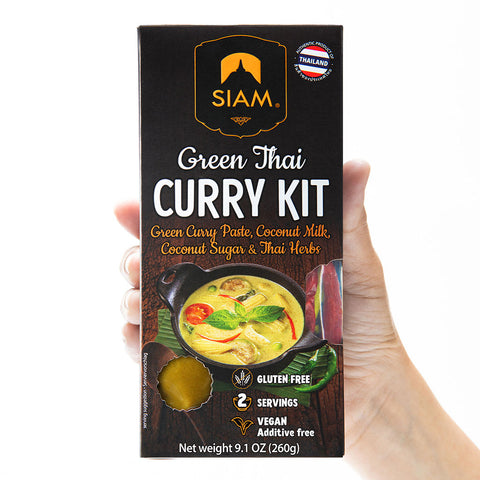 Siam Green Thai Curry Kit packaging held by a hand on a white background