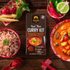 Siam Red Thai Curry Kit with ingredients and a prepared dish on a wooden table